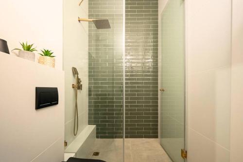 a bathroom with a shower with a glass door at Romano Neve Tzedek Penthouse in Tel Aviv