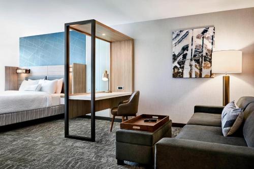 um quarto de hotel com uma cama e uma secretária em SpringHill Suites by Marriott Columbia near Fort Jackson em Columbia