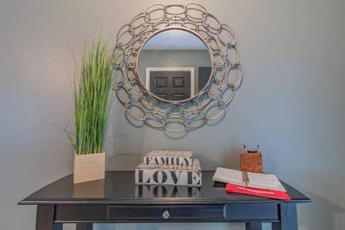 a black table with a mirror on a wall at Charming Conway Getaway in Conway