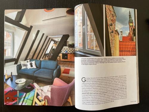 a page of a magazine with a living room at Długa Design Apartment - Old Town in Gdańsk