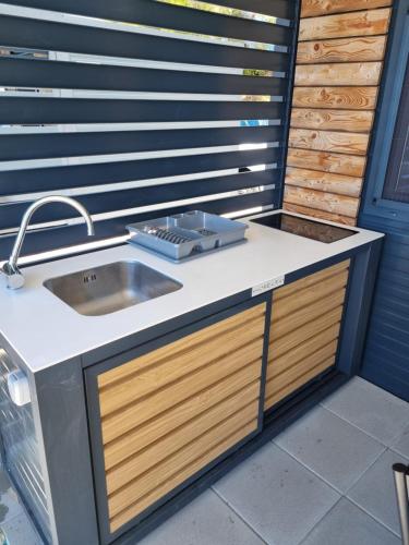 a kitchen with a sink and a counter top at Hipo camp Mobil home Arta in Pakoštane