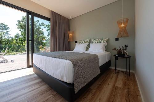Cama ou camas em um quarto em Ermo Loft - Casas do Ermo