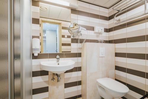 a bathroom with a sink and a toilet at Hestia Hotel Strand in Pärnu