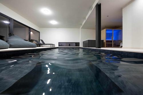 a swimming pool in the middle of a room at Ermo Loft - Casas do Ermo in Fafe