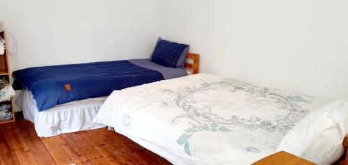 two twin beds in a room with at The Old Post Office Lodge in Enniskillen