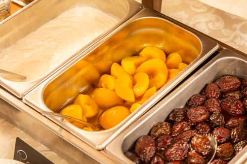 a tray of food with fruits and other food items at Hotel San Michele in Cortona