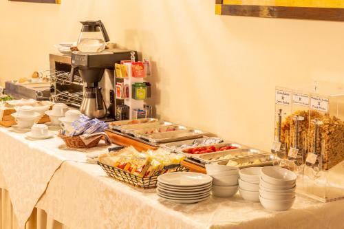 a buffet line with plates and food on a table at Hotel San Michele in Cortona