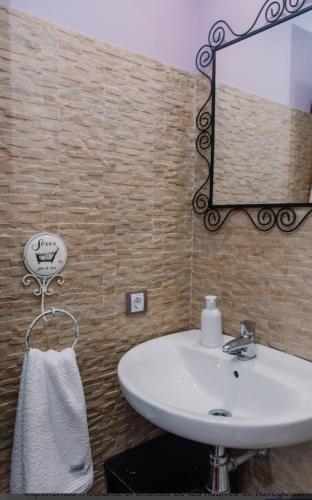 a bathroom with a white sink and a mirror at Entrada Río Lobos in Hontoria del Pinar