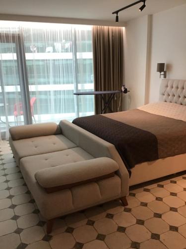 a bedroom with a large bed and a couch at Batumi Sea View in Batumi