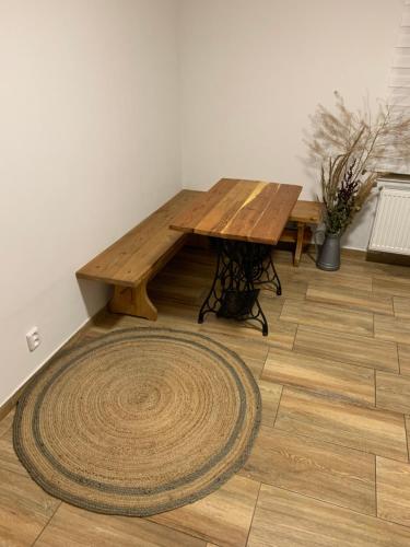 a wooden table in a room with a rug at Apartmány na Vršku in Plzeň