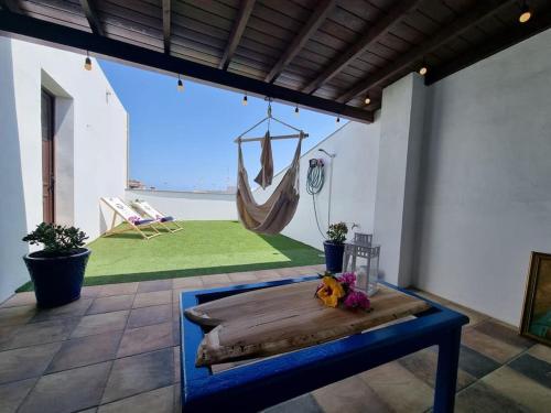 a room with a table and a hammock in it at Bel Air surf escape in Cotillo
