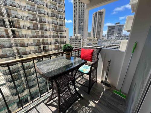 a balcony with a table and chairs on a balcony at WELLCOME TO LOVELY CONDO 2 BEDS 2 BATHS FREE PARKING IN WAIKIKI BEACH in Honolulu