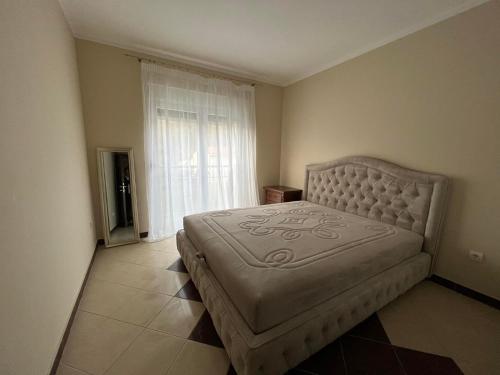 a bedroom with a bed in a room with a window at Przno apartment in Budva