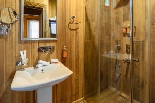 a bathroom with a sink and a shower at Hotel Chateau Kvirike in K'obulet'i