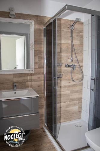 a bathroom with a shower and a sink at Azyl in Dębki