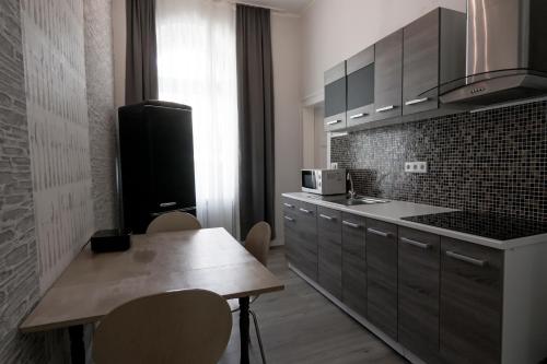 a kitchen with a table and a sink and a microwave at P8 Ferienwohnung in Remscheid
