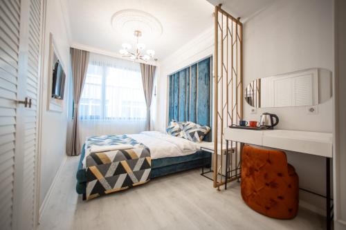a bedroom with a bed and a window at Megalos Galata Hotel in Istanbul