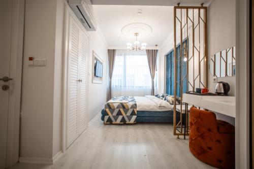 a bedroom with a bed and a window at Megalos Galata Hotel in Istanbul
