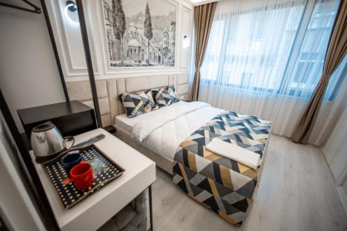 a small room with a bed and a table with a table sidx sidx at Megalos Galata Hotel in Istanbul