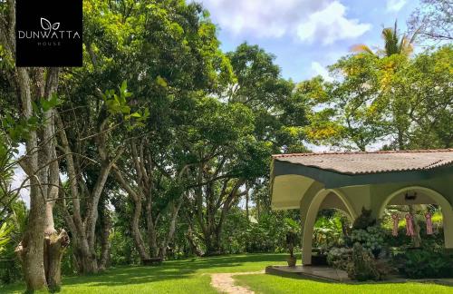 a gazebo in a park with trees at Dunwatta House in Kandy