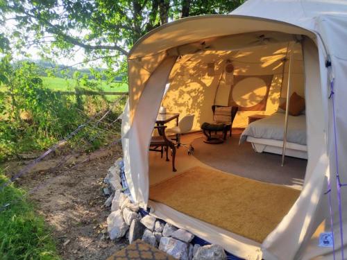 a tent with a bed and a table in it at South Devon Luna Bell Tent in Newton Abbot
