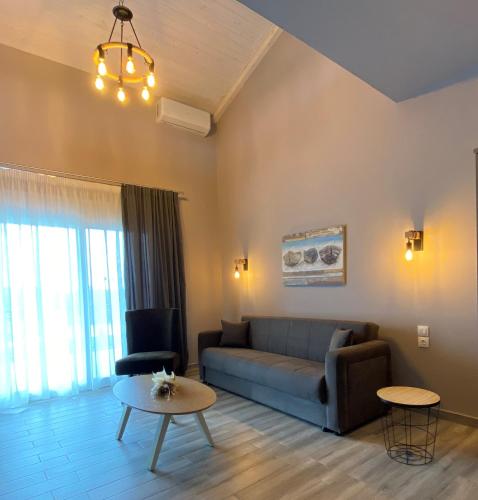 a living room with a couch and a table at Vot villas in Ormos Panagias