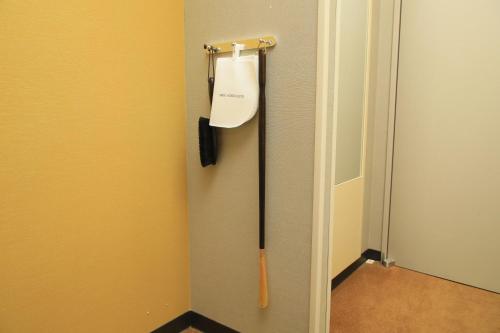 a baseball bat hanging on a locker door at Richmond Hotel Narita in Narita