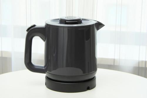 a black electric kettle sitting on a table at Richmond Hotel Narita in Narita