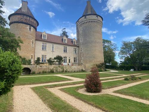 two towers of a castle with a garden at Château de Bouesse en Berry in Bouesse