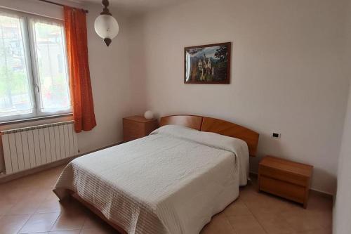 a small bedroom with a bed and a window at Wayne's house, a short walk to the waterfalls in Bagnone