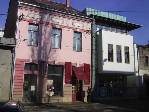 a pink building on the corner of a street at Apartment Romana in Sarajevo
