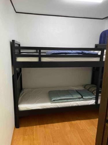 a room with two bunk beds in a room at Dongming House in Seoul