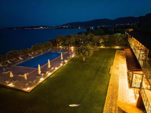 an aerial view of a resort with a pool at night at Europa Beach Hotel in Galaxidhion