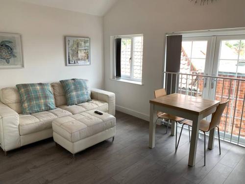a living room with a couch and a table at Platform Church View Apartment Hull in Hedon