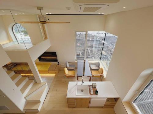 a living room with a staircase and a white table at Exclusive Penthouse with Great Hanok Village View in Seoul