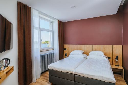 a bedroom with a large bed and a window at Hestia Hotel Haapsalu SPA in Haapsalu