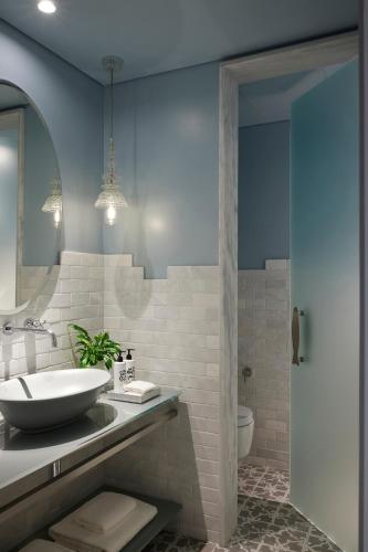 a bathroom with a sink and a mirror at Fresh Hotel, a member of Design Hotels in Athens