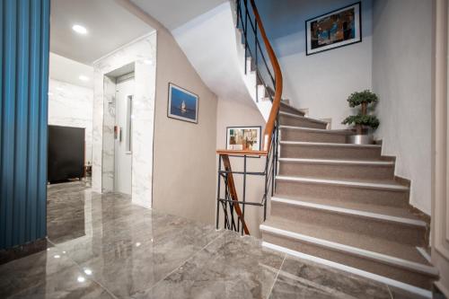 a staircase in a home with a blue wall at Megalos Galata Hotel in Istanbul