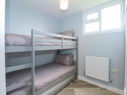 a bunk bed room with two bunk beds and a window at Number 9 in Great Yarmouth