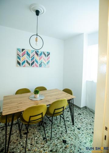 a dining room with a wooden table and chairs at Explore Greece from Apartment with Private Garden in Chalkida