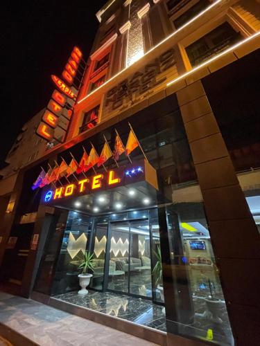 a building with a sign in front of it at night at Grand Nergiz Otel in Antalya