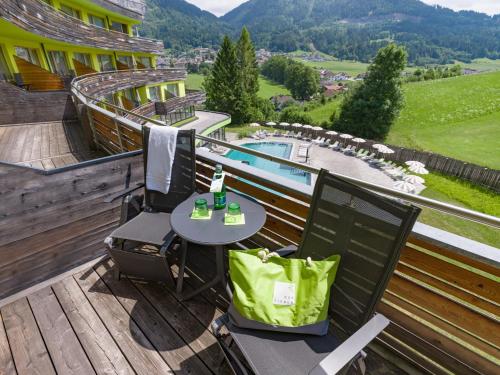 a patio with a table and chairs on a deck at DAS SIEBEN - Adults Only in Bad Häring