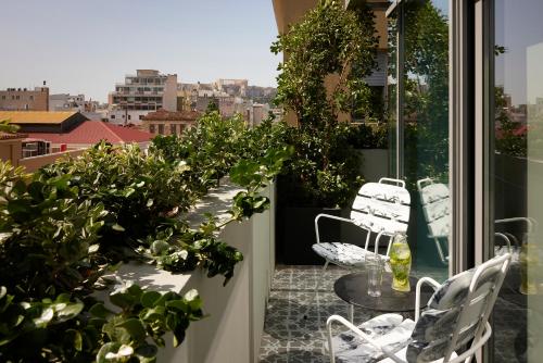 a balcony with a table and chairs and plants at Fresh Hotel, a member of Design Hotels in Athens