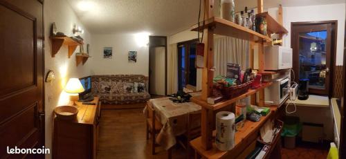a living room with a couch and a table at Montagne aux Contamines Montjoie Appartement 6-7 personnes in Les Contamines-Montjoie