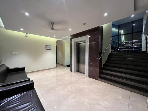 a lobby with a staircase and a stair case at TGS Dine Inn in Port Blair