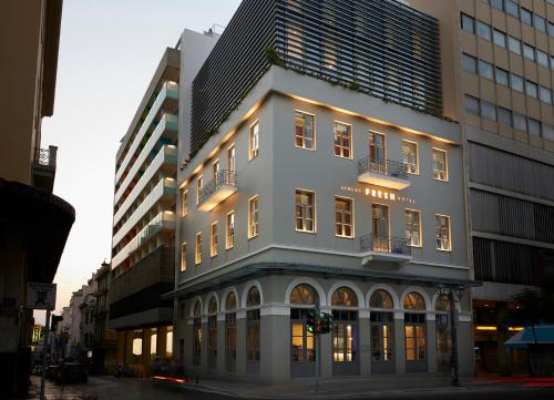 a tall building with lights on in a city at Fresh Hotel, a member of Design Hotels in Athens