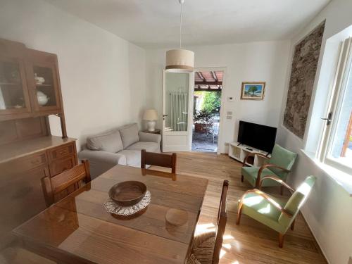 a living room with a table and chairs at Villa Vanna - the ancient Forte just in the center in Forte dei Marmi