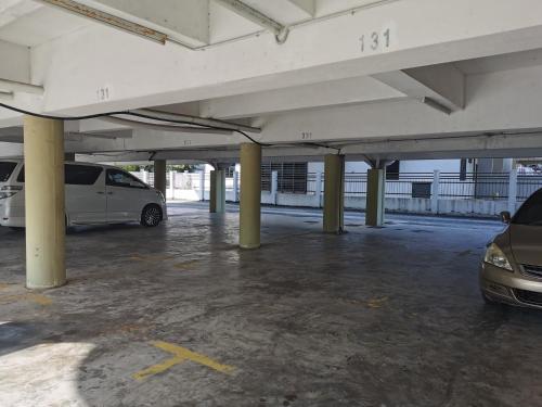 a parking lot with a white van parked in it at DIY Palm Court Bedroom in Kuantan