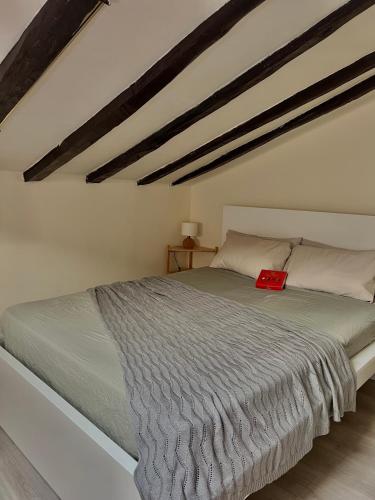 a bedroom with a bed with a red book on it at Charming apartment in the heart of Madrid in Madrid