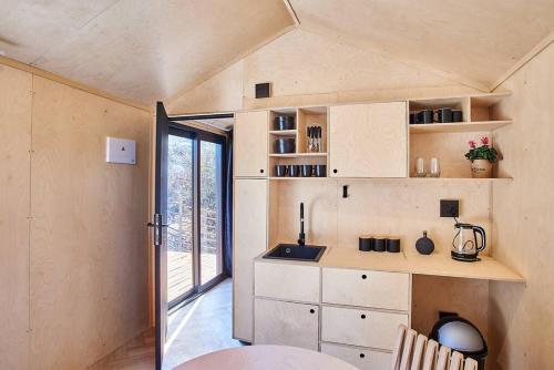 a small kitchen in a tiny house with a window at Clarens 'Gazza' Pod in Clarens